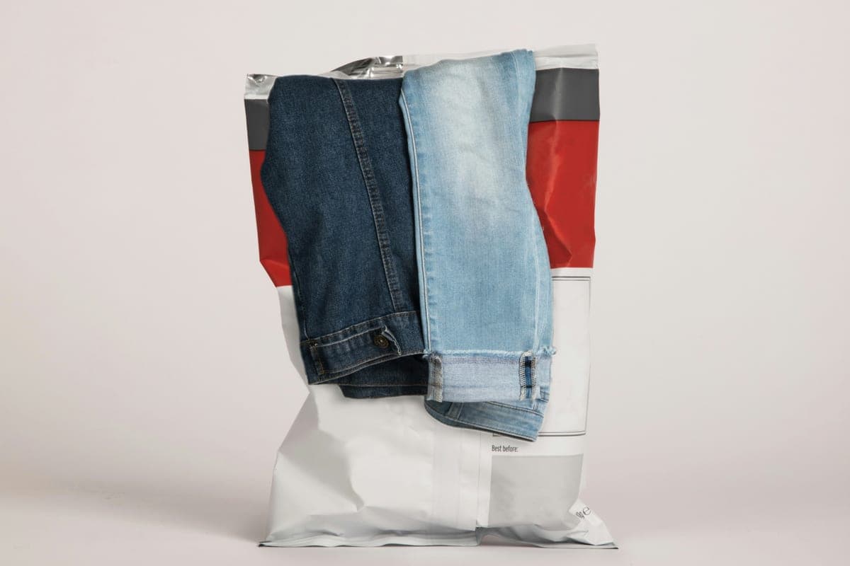 Two pairs of jeans tucked into an opened foil snack bag